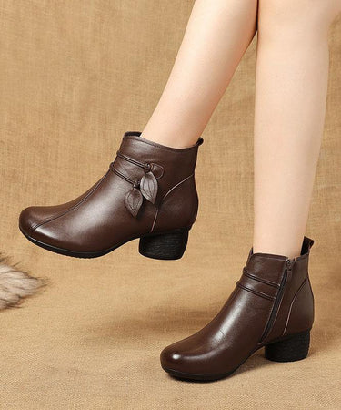 Front-facing view of heeled ankle boot with leaf detail at the ankle
