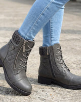 Ankle boots worn with a midi skirt, full-length view
