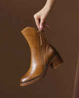 Close-up of the tassel zip pull on the outer side of the ankle boot