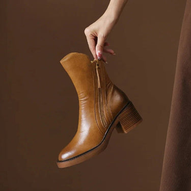 Close-up of the tassel zip pull on the outer side of the ankle boot