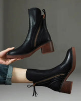 Side profile showing the block heel and rounded toe of the ankle boot