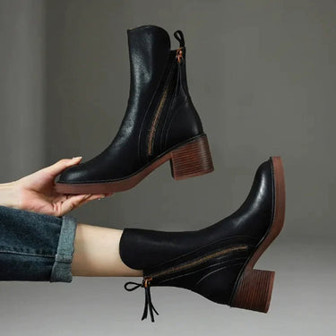Side profile showing the block heel and rounded toe of the ankle boot