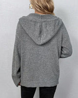 Side view showing the hip length and relaxed fit of the hooded cardigan