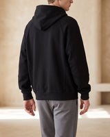 Three-quarter view of the zip up hoodie cardigan worn casually