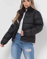 Detail shot of a front zip pocket on the puffer jacket