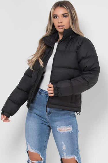 Detail shot of a front zip pocket on the puffer jacket