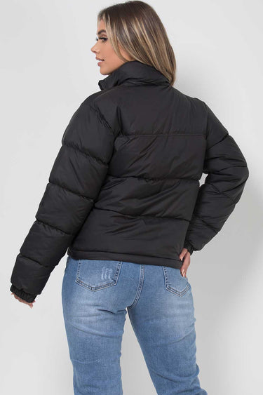 Back view of the quilted puffer jacket showing the hood and hem length