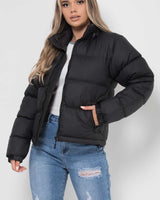 Three-quarter view showing the overall fit and length of the puffer jacket