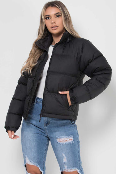 Three-quarter view showing the overall fit and length of the puffer jacket