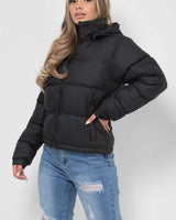 Detail of the cuffs and lower hem of the longline puffer jacket