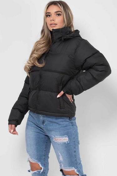 Detail of the cuffs and lower hem of the longline puffer jacket