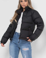 Front view of a longline quilted hooded puffer jacket with zip fastening