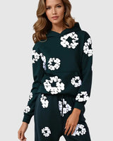 Front view of hooded tracksuit set with floral detail on model