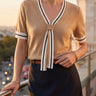Three-quarter view of the knit top showing tie and trim detail