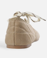 Close-up of the adjustable cross-lace upper on the ballet flat