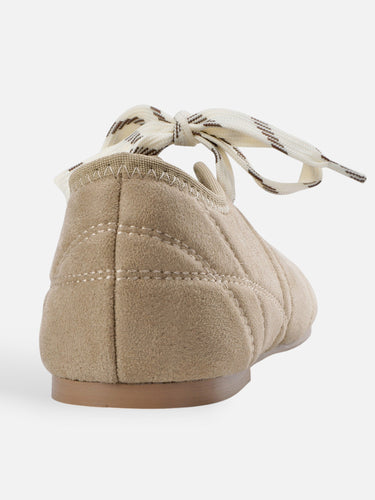 Close-up of the adjustable cross-lace upper on the ballet flat
