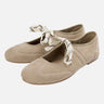 Front view of a lace-up ballet flat with cross-strap detail