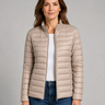 Front view of a quilted lightweight puffer jacket with stand collar and zip front