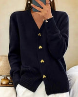 Relaxed-fit longline knit cardigan with V-neckline and gold heart-shaped buttons, front view