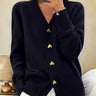 Relaxed-fit longline knit cardigan with V-neckline and gold heart-shaped buttons, front view