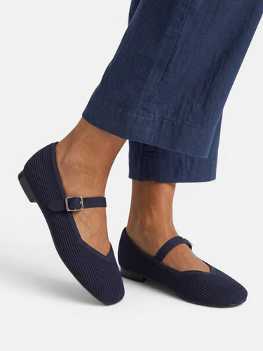 Mary Jane flats on a flat surface showing sole and profile