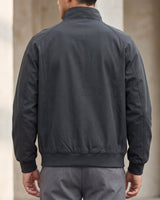 Side view showing ribbed cuffs and hem of a faux leather bomber jacket