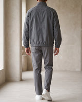Men's baseball jacket showing ribbed cuffs and hem detail, side view