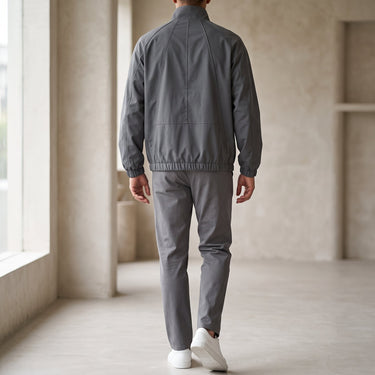 Men's baseball jacket showing ribbed cuffs and hem detail, side view