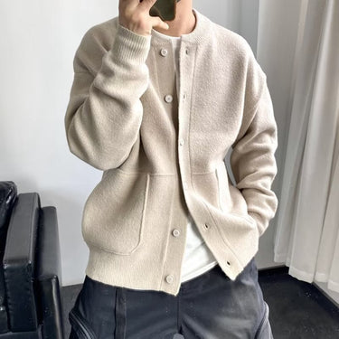 Side view of men's knit cardigan showing patch pocket and ribbed cuff detail