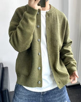 Men's knit cardigan with button front, patch pockets and ribbed cuffs, worn front-facing