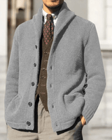Close-up of the button placket and round neckline on a men's knit cardigan
