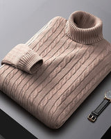 Men's cable knit jumper styled with trousers, three-quarter view