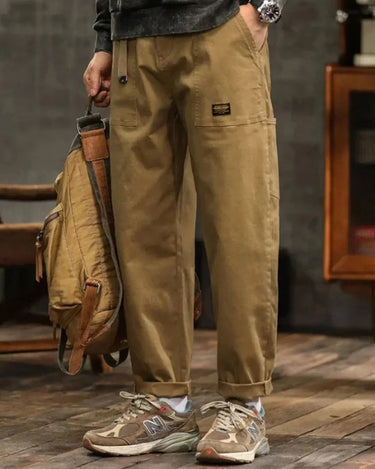 Front waist pleat detail on men's wide-leg cargo trousers