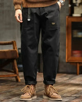 Side profile of men's cargo trousers showing wide-leg silhouette