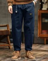 Full-length view of men's cargo trousers styled in an urban setting