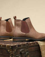 Men's Chelsea boot on a plain background showing full silhouette