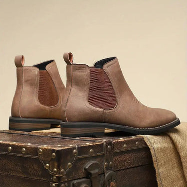 Men's Chelsea boot on a plain background showing full silhouette