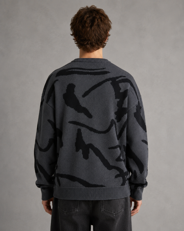 Men's graphic knit jumper shown with drop shoulder silhouette, side view