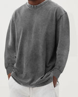 Side profile of men's chunky knit jumper showing dropped shoulder detail