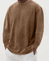 Men's chunky knit jumper layered over a collared shirt, full-length view