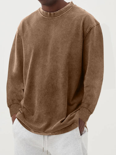 Men's chunky knit jumper layered over a collared shirt, full-length view