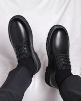 Men's derby boots from above showing lace-up vamp and rounded toe