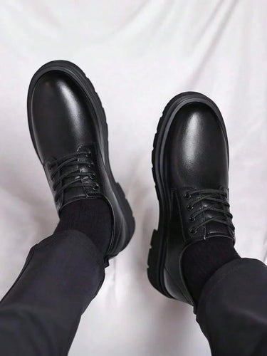 Men's derby boots from above showing lace-up vamp and rounded toe