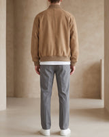 Side view showing the relaxed silhouette and ribbed hem of the jacket