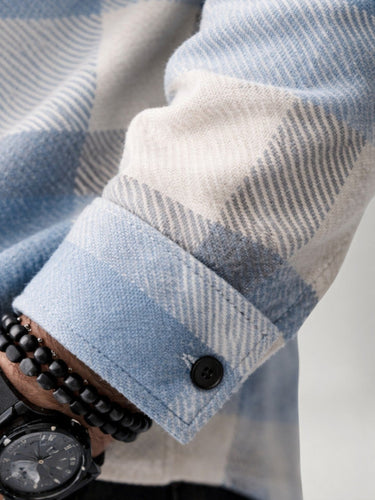 Chest pocket detail on men's plaid flannel overshirt