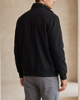 Side view showing the ribbed cuffs and hem of the leather bomber jacket