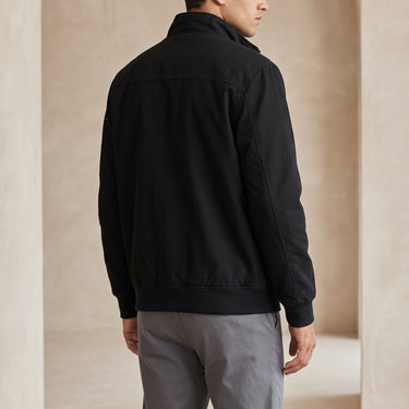 Side view showing the ribbed cuffs and hem of the leather bomber jacket