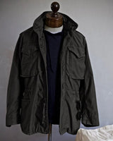 Model wearing the field jacket layered over a knit jumper with jeans