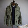 Front view of men's hooded field jacket with snap-button chest pockets and cargo pockets