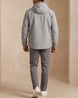 Side view showing the puffer silhouette and zip hip pocket